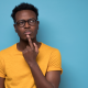man in deep thoughts with his index finger on his lower lip