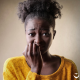 Worried girl with fingers in mouth