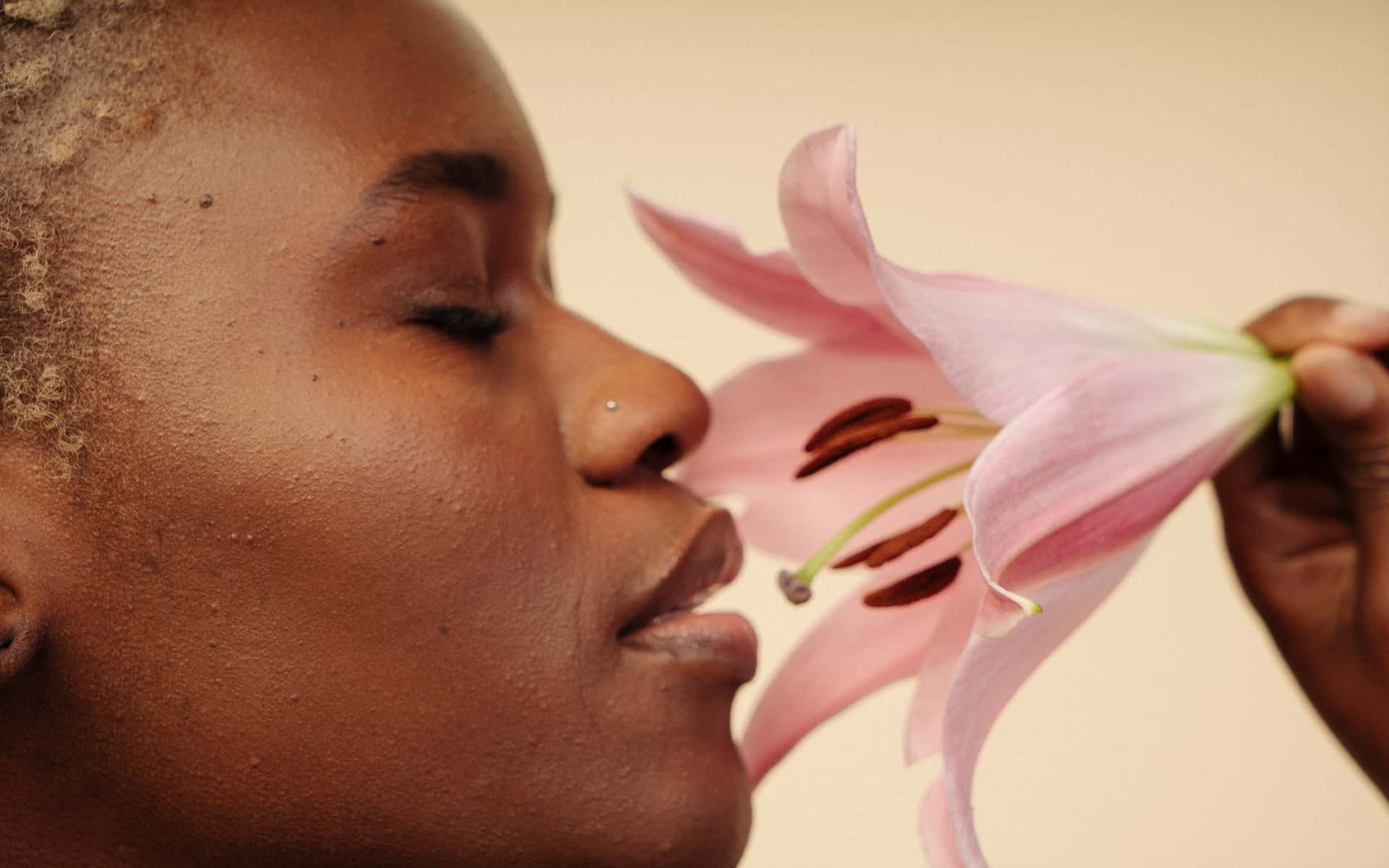 Woman sniffing flower