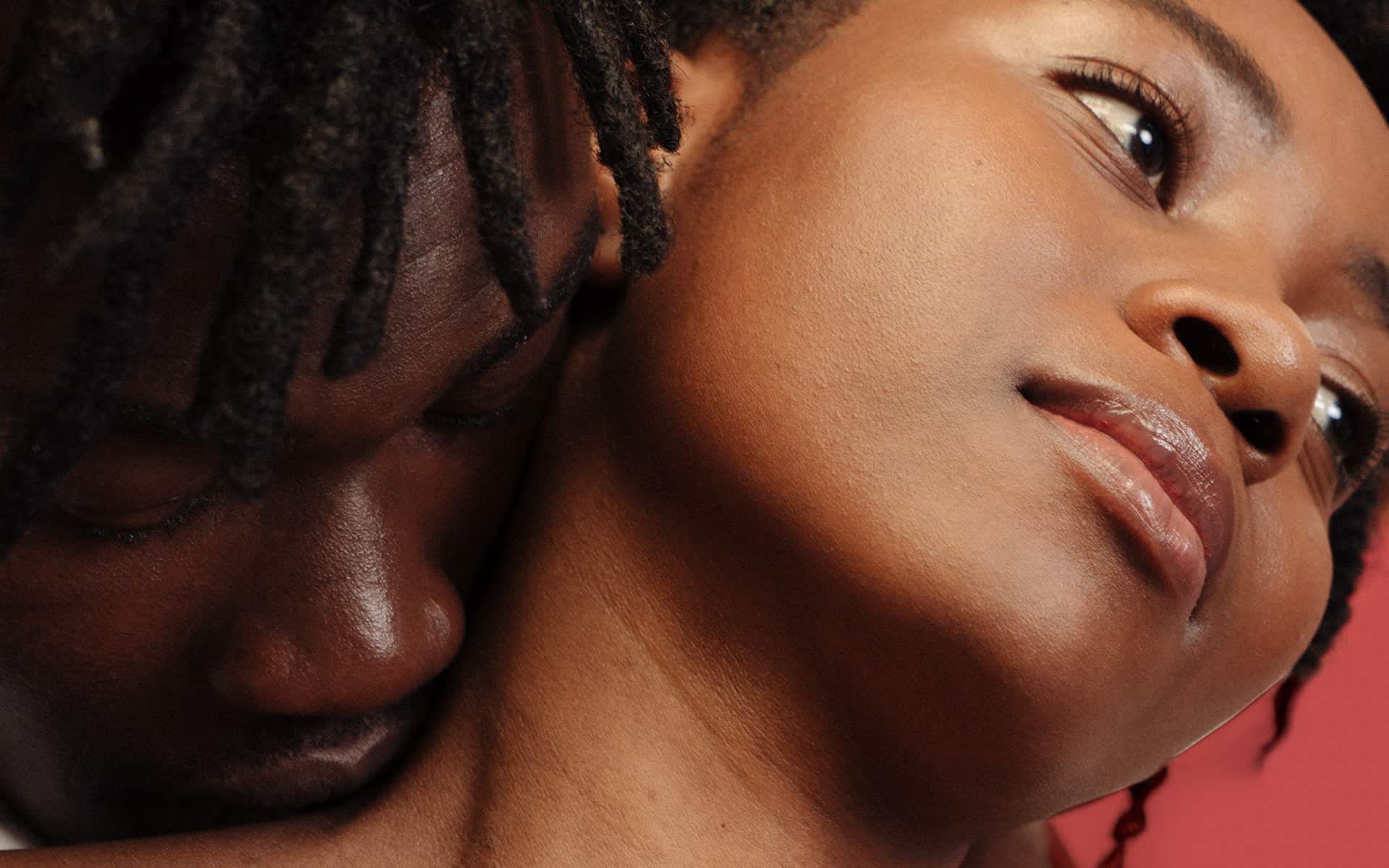 Two people embracing each other, him kissing her neck