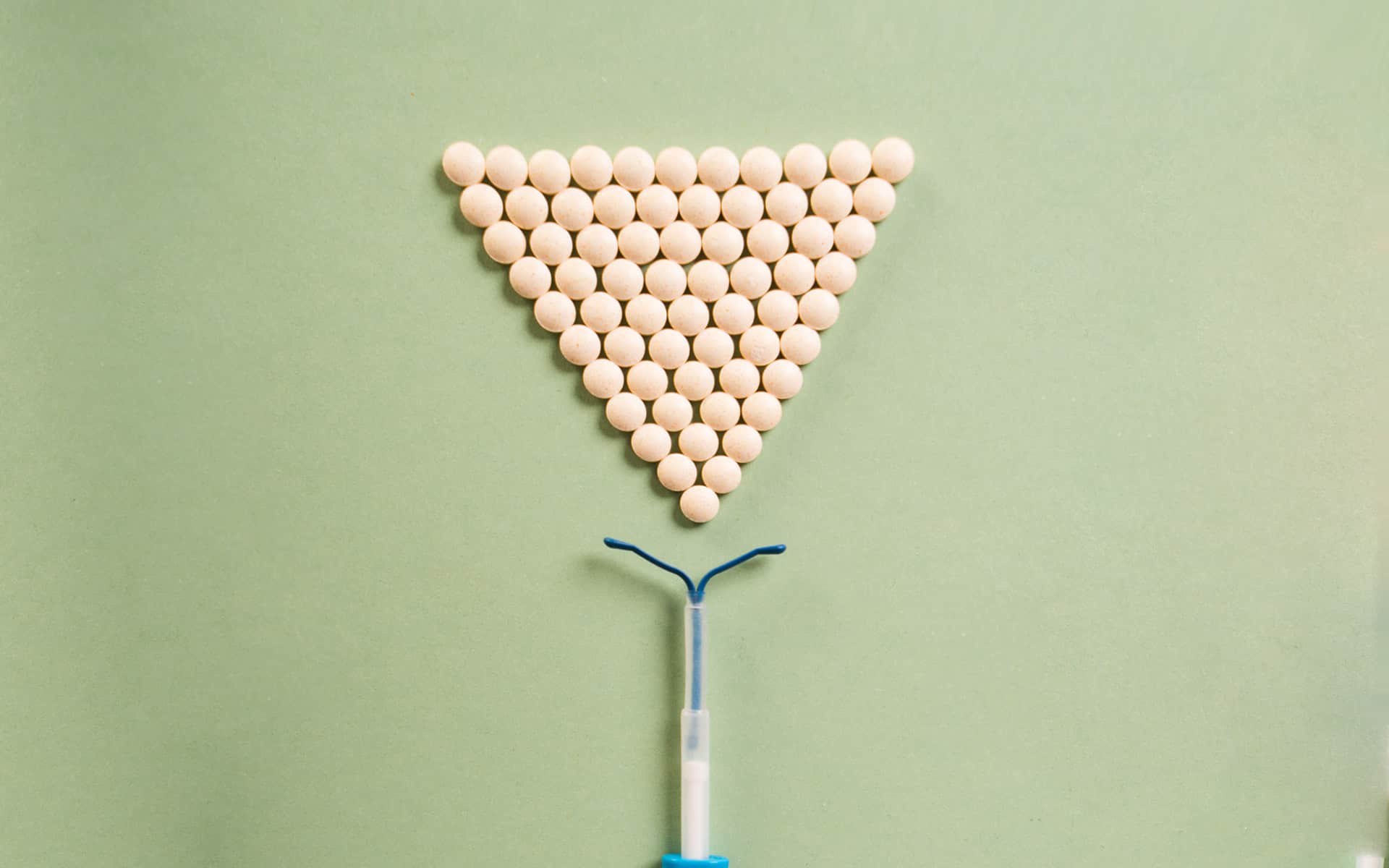 IUD and pills, pills lined up like a funnel