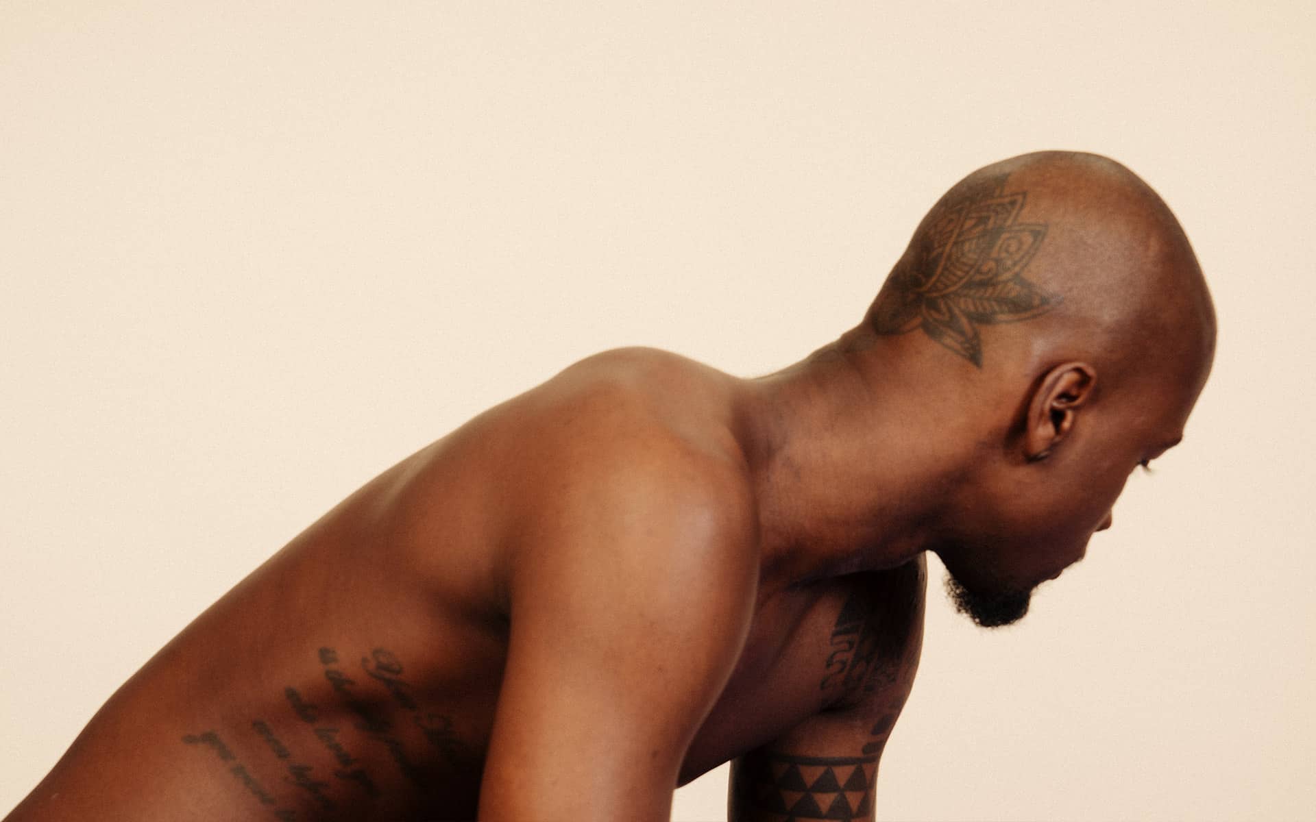 Man with naked torso turning away in frustration