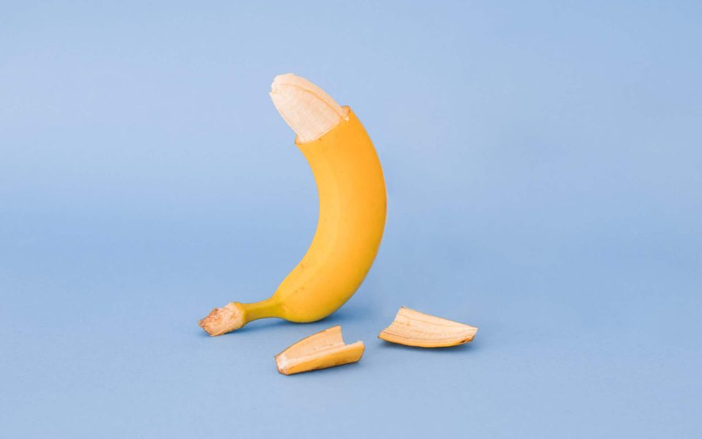 ripe banana peeled only at the top