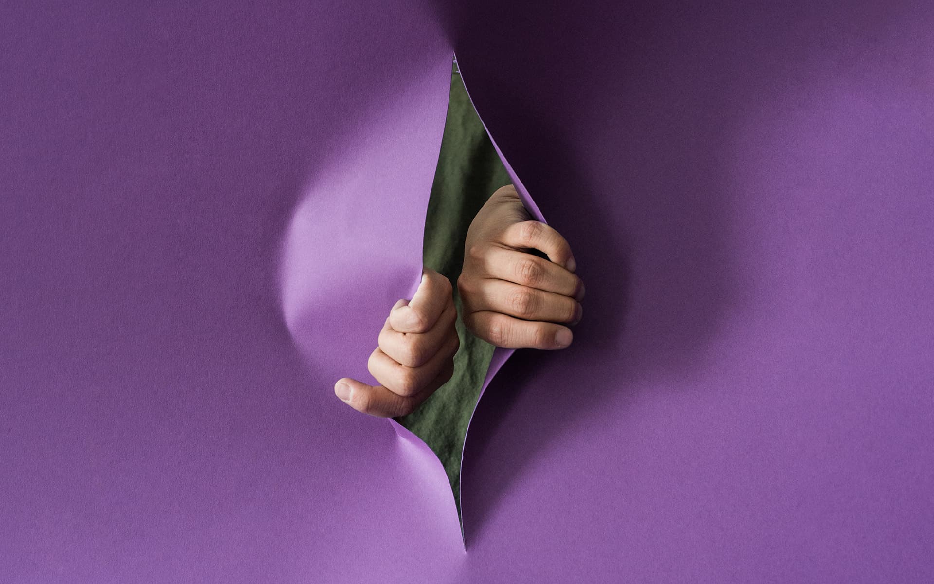 Hands coming out from behind a wall of purple