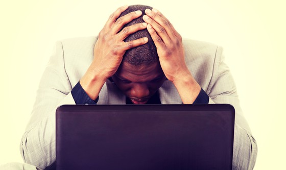 Sad man staring at his laptop