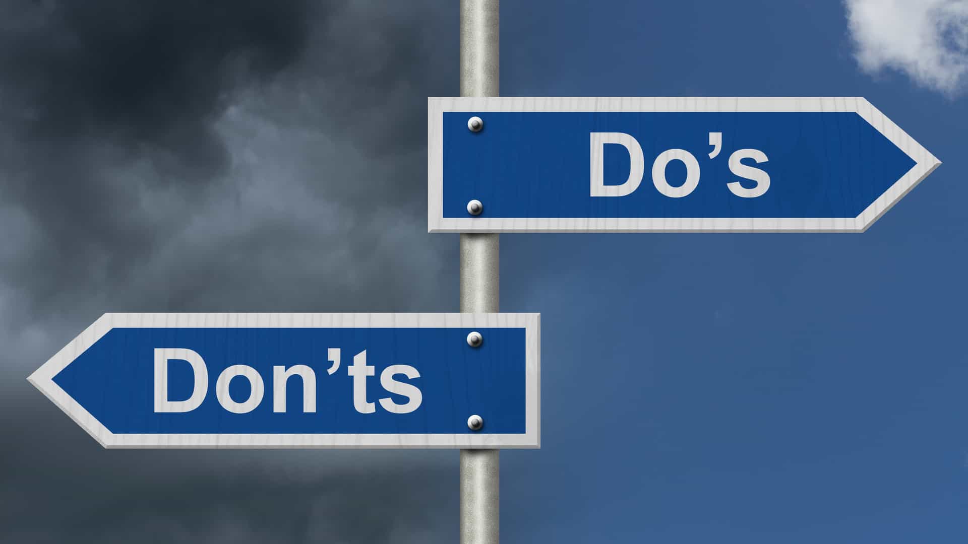 Blue road sign with words Do's Don'ts with stormy and bright sky background