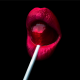 red lips eating a red lory pop