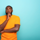 scared african man with orange shirt