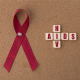 Red ribbon alongside a chips cross bearing HIV/AIDS