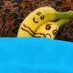 Two bananas in bed and in a cuddling position