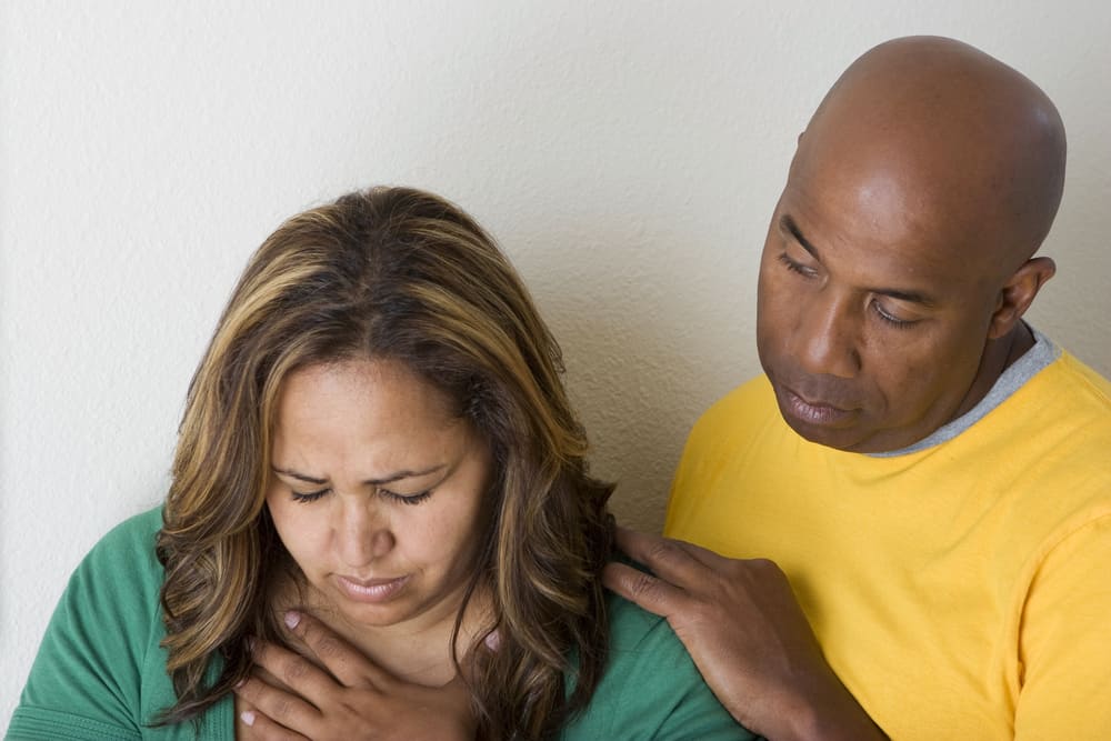 Man comforting upset woman