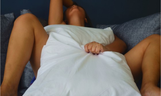 woman in bed with intense orgasm