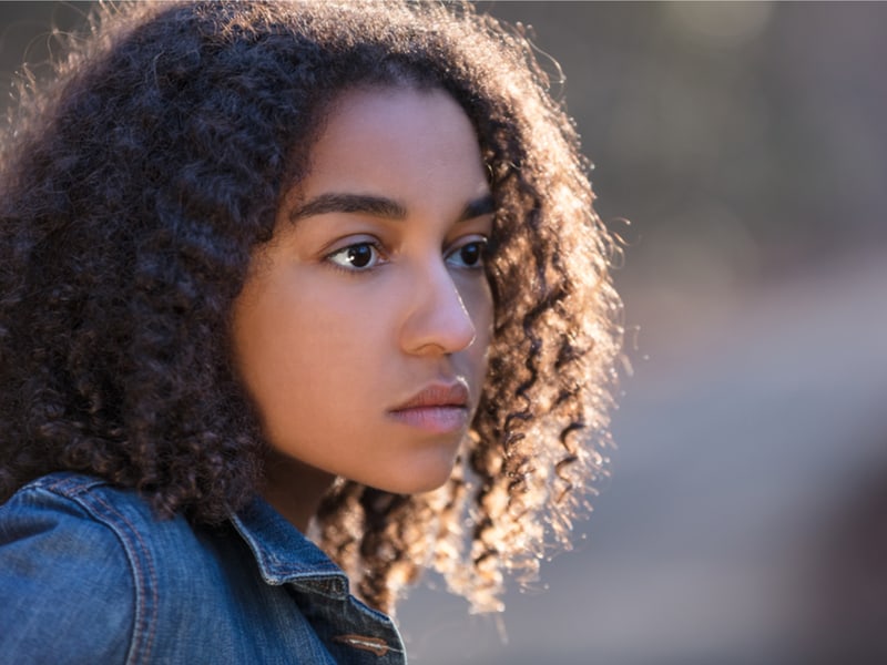 Sad looking young woman staring into the distance