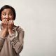scared women with hands in mouth