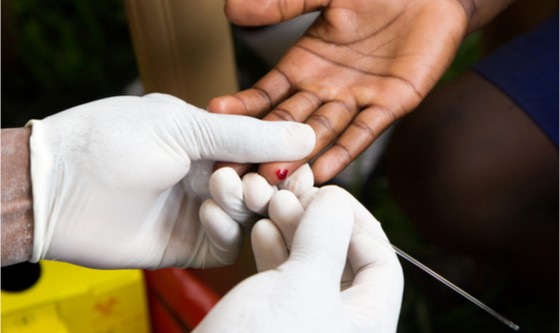 Man taking blood from another person for an HIV test