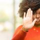 african woman annoyed with bad attitude making stop sign with hand, saying no