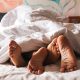 Feet of a young couple that lying on the bed