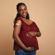 pregnant woman hugging her big tummy,
