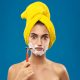 young woman shaves her face